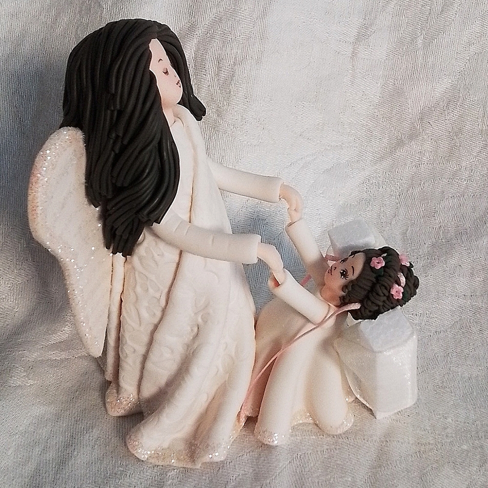 Kneeded Angel's "Mother and Daughter" Figurine: Caucasian, both with dark hair.